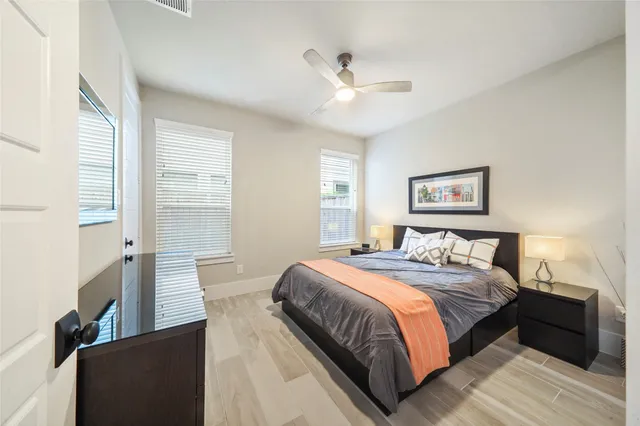 a bedroom with a large bed and a chandelier