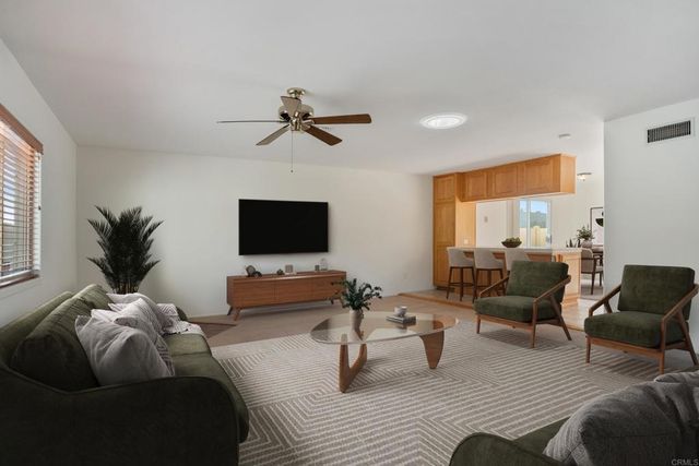 a view of room with a ceiling fan and window