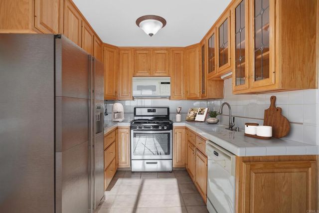 a kitchen with stainless steel appliances granite countertop a sink and a stove