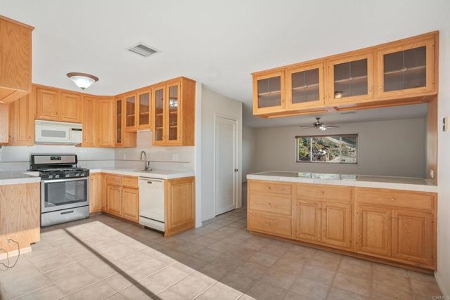 an empty room with a ceiling fan and a window