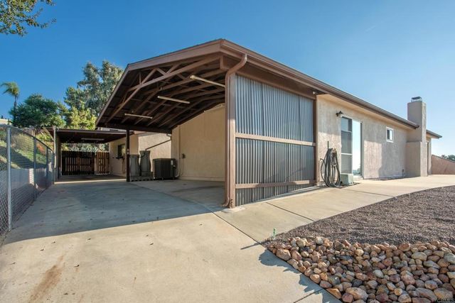 an aerial view of a house with yard swimming pool and lake view