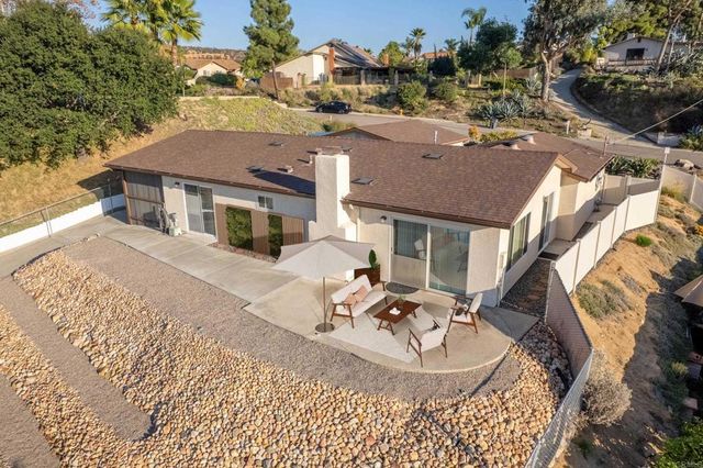 a aerial view of a house with a yard and balcony