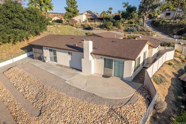 a view of a patio with couches table and chairs and potted plants