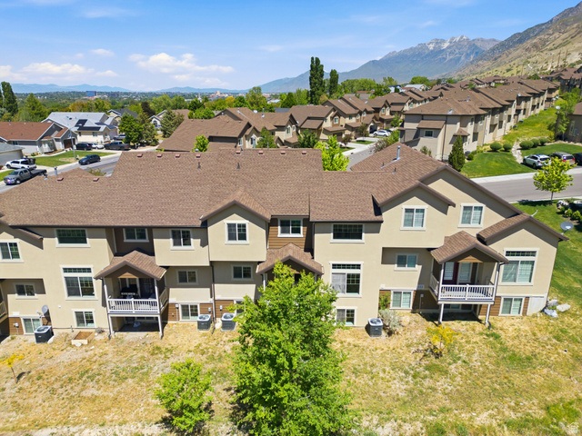 1614 Aspen Loop Provo, UT 84606 - Photo 41 of 47 Townhome community featuring multi-story units with tan stucco exteriors and brown shingle roofs