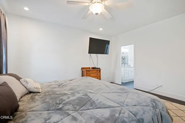 a bedroom with a large bed and a flat screen tv