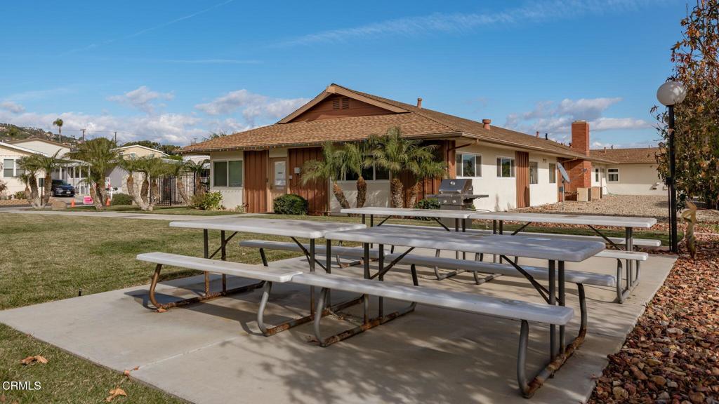 11100 Telegraph Road, Unit 88 Ventura, CA 93004 - Photo 24 of 24 a view of a patio with table and chairs with wooden floor and fence