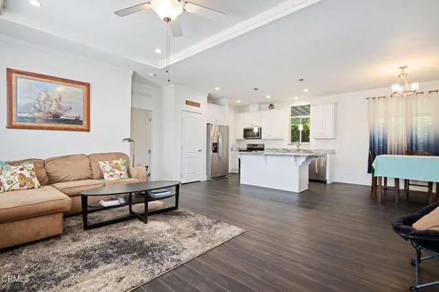 a living room with furniture and kitchen view