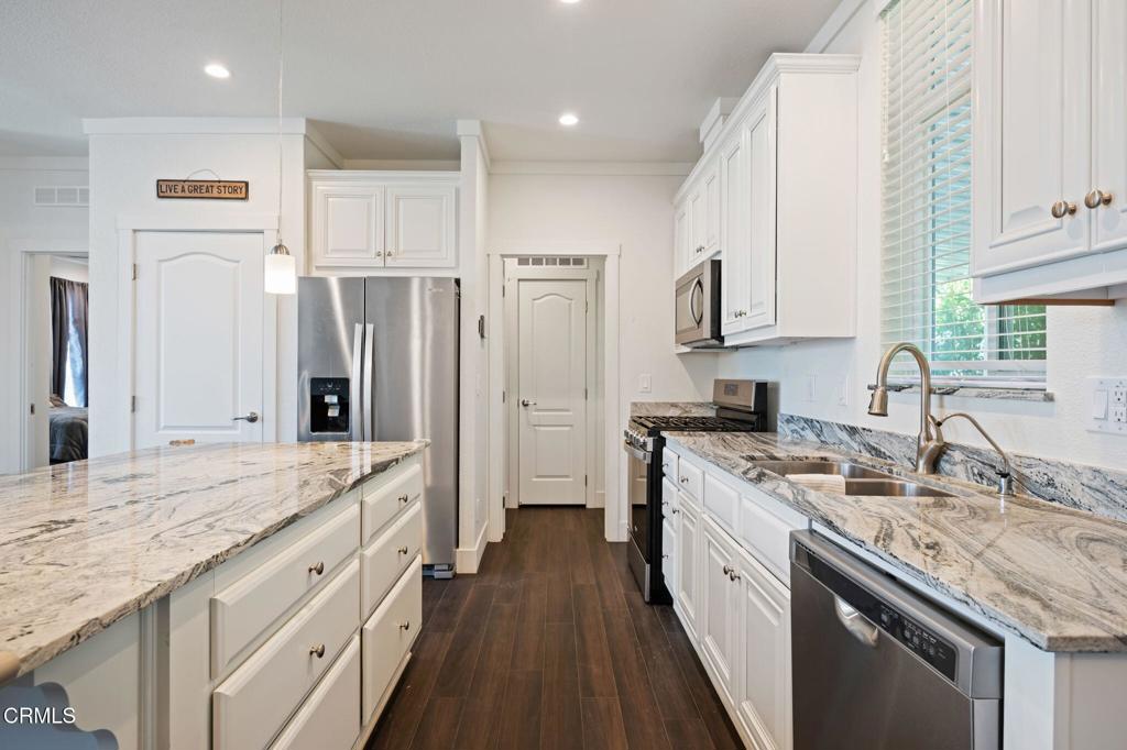 11100 Telegraph Road, Unit 88 Ventura, CA 93004 - Photo 8 of 24 a large kitchen with stainless steel appliances granite countertop a sink stove refrigerator and cabinets