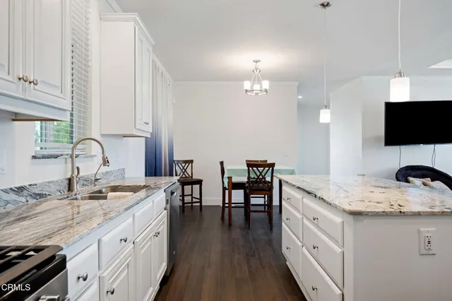 a kitchen with sink stove top oven and microwave