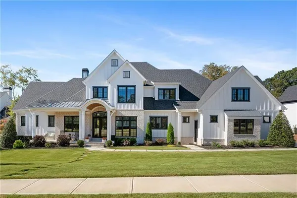 a front view of a house with a garden