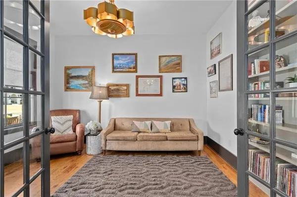 a living room with furniture a fireplace and a flat screen tv