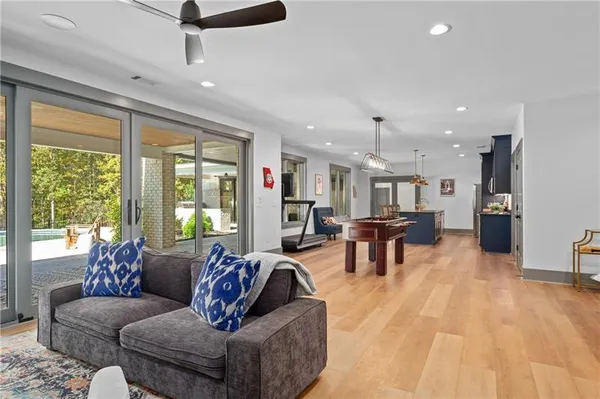 a kitchen with stainless steel appliances granite countertop wooden cabinets a dining table and chairs