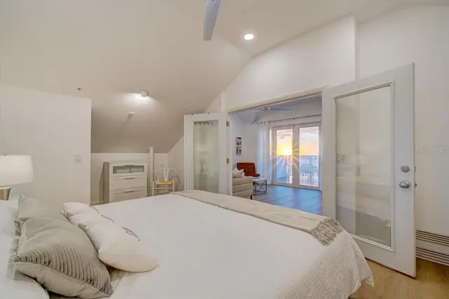 a bedroom with a bed and a large mirror