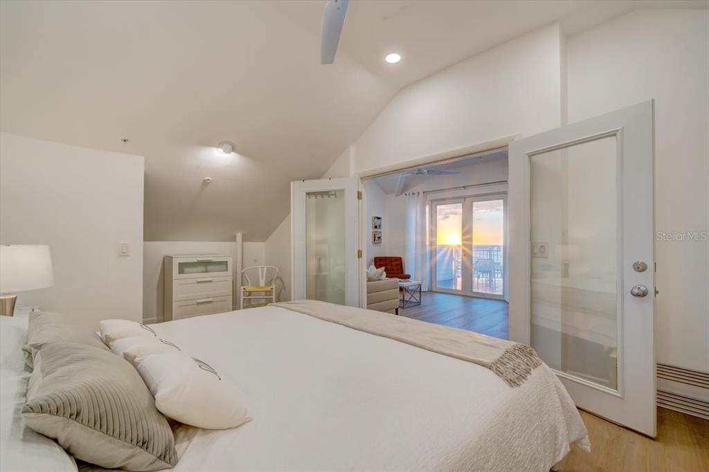 17852 Lee Avenue Redington Shores, FL 33708 - Photo 14 of 38 a bedroom with a bed and a large mirror