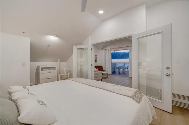 a bedroom with a bed and a large mirror