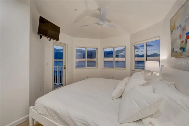 a bedroom with a bed and flat screen tv