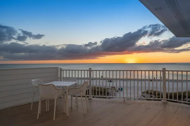 a view of a balcony with furniture