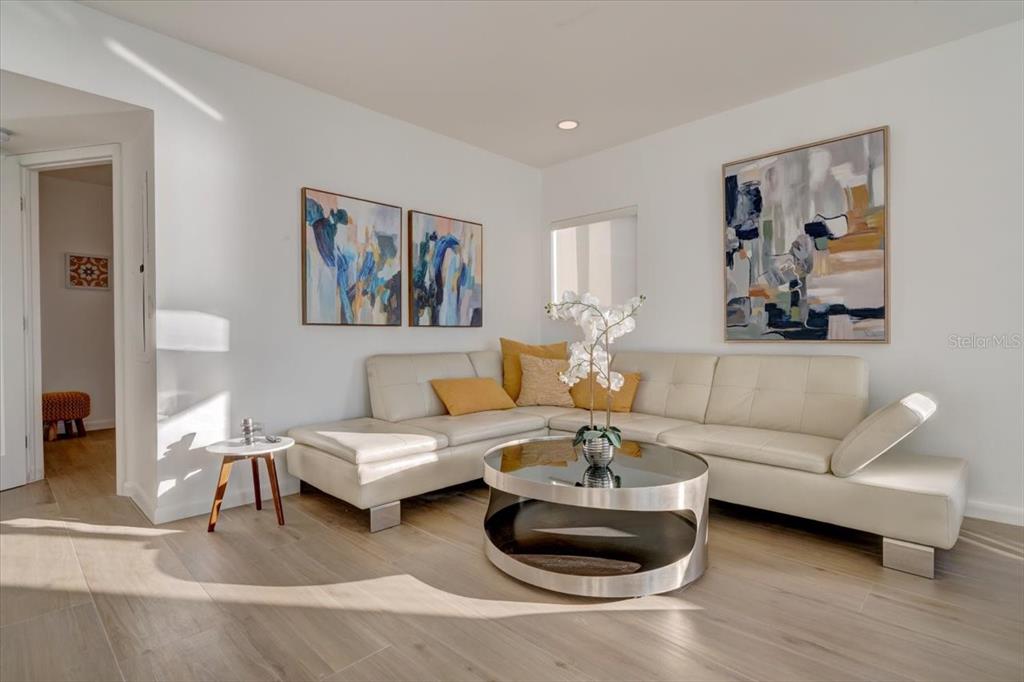 17852 Lee Avenue Redington Shores, FL 33708 - Photo 3 of 38 a living room with furniture and a painting on the wall