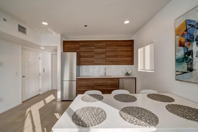 a hallway with a dresser and window