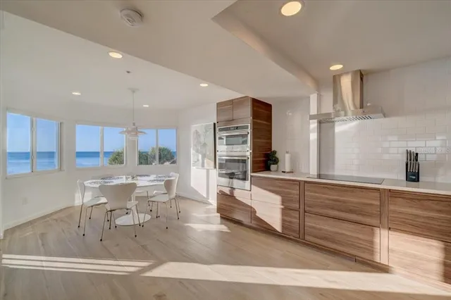 a kitchen with stainless steel appliances granite countertop a sink and a refrigerator