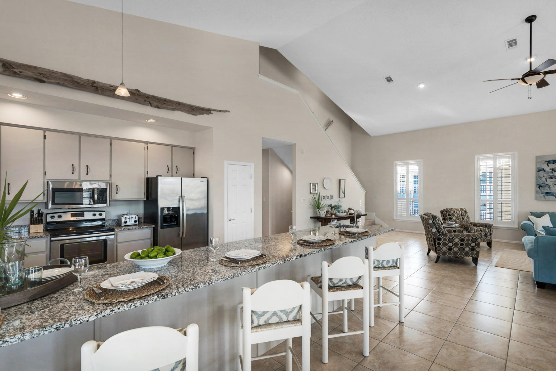 39 Sandy Lane Santa Rosa Beach, FL 32459 - Photo 19 of 87 a kitchen with stainless steel appliances kitchen island granite countertop a refrigerator a stove a dining table and chairs with wooden floor