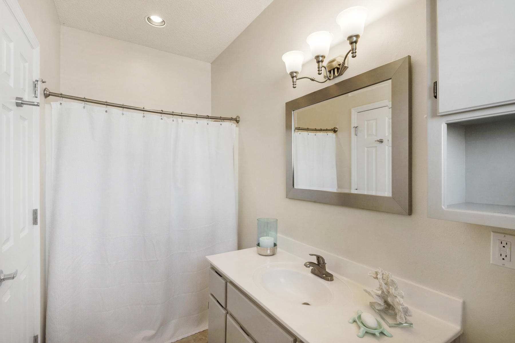 39 Sandy Lane Santa Rosa Beach, FL 32459 - Photo 29 of 87 a bathroom with a sink a mirror and a shower