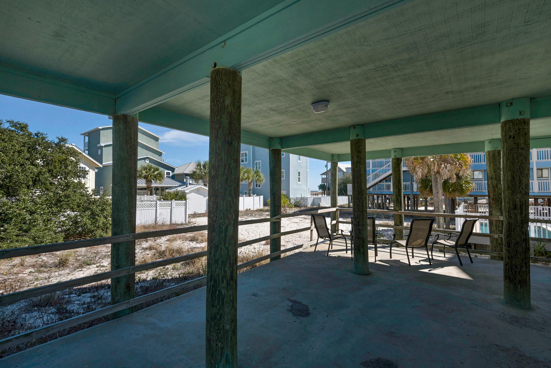 39 Sandy Lane Santa Rosa Beach, FL 32459 - Photo 51 of 87 a view of a porch with chairs and floor to ceiling window and an entrance