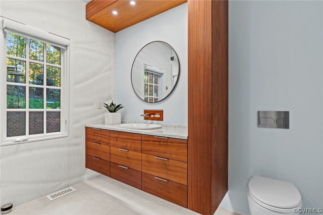 13213 Edmonton Drive Midlothian, VA 23113 - Photo 21 of 49 a bathroom with a toilet sink and mirror
