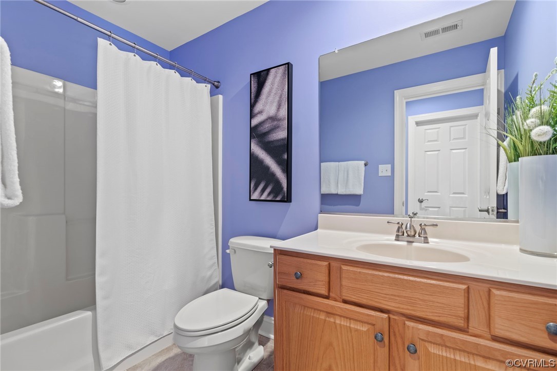 13213 Edmonton Drive Midlothian, VA 23113 - Photo 45 of 49 a bathroom with a toilet sink and mirror