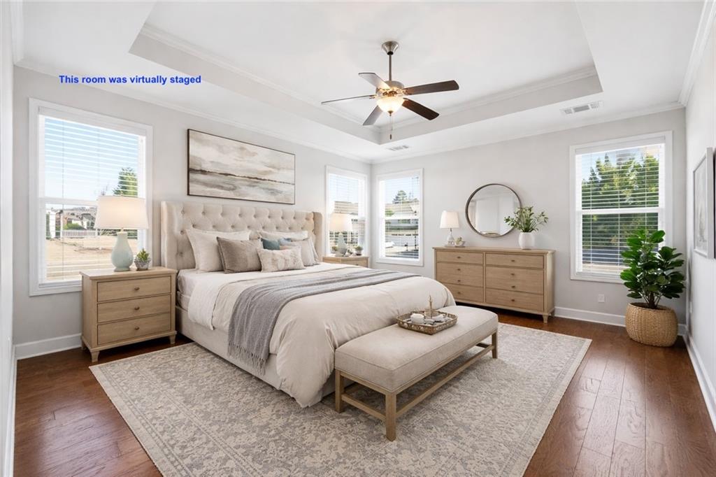 3751 Golden Leaf Point Southwest Gainesville, GA 30504 - Photo 12 of 45 a bedroom with a large bed and a chandelier