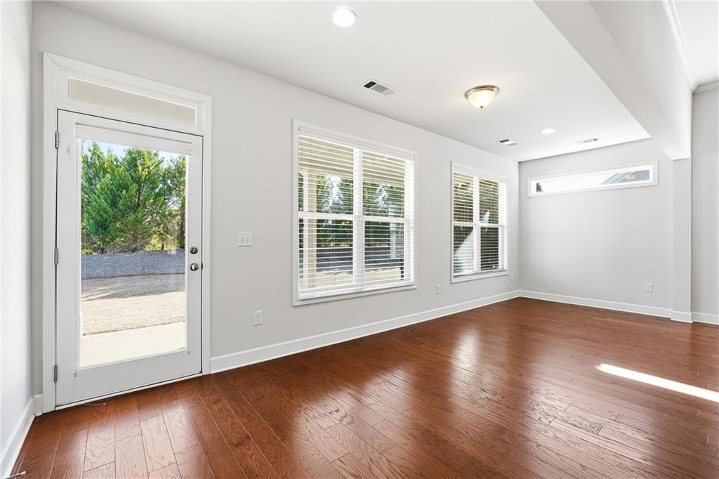 3751 Golden Leaf Point Southwest Gainesville, GA 30504 - Photo 13 of 45 a view of an empty room with wooden floor and a window