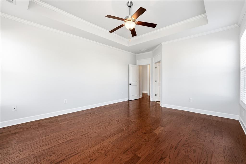 3751 Golden Leaf Point Southwest Gainesville, GA 30504 - Photo 15 of 45 an empty room with wooden floor and ceiling fan