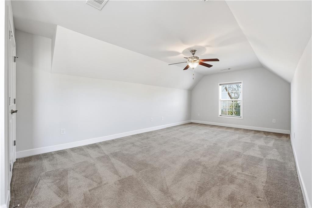 3751 Golden Leaf Point Southwest Gainesville, GA 30504 - Photo 22 of 45 an empty room with windows and ceiling fan