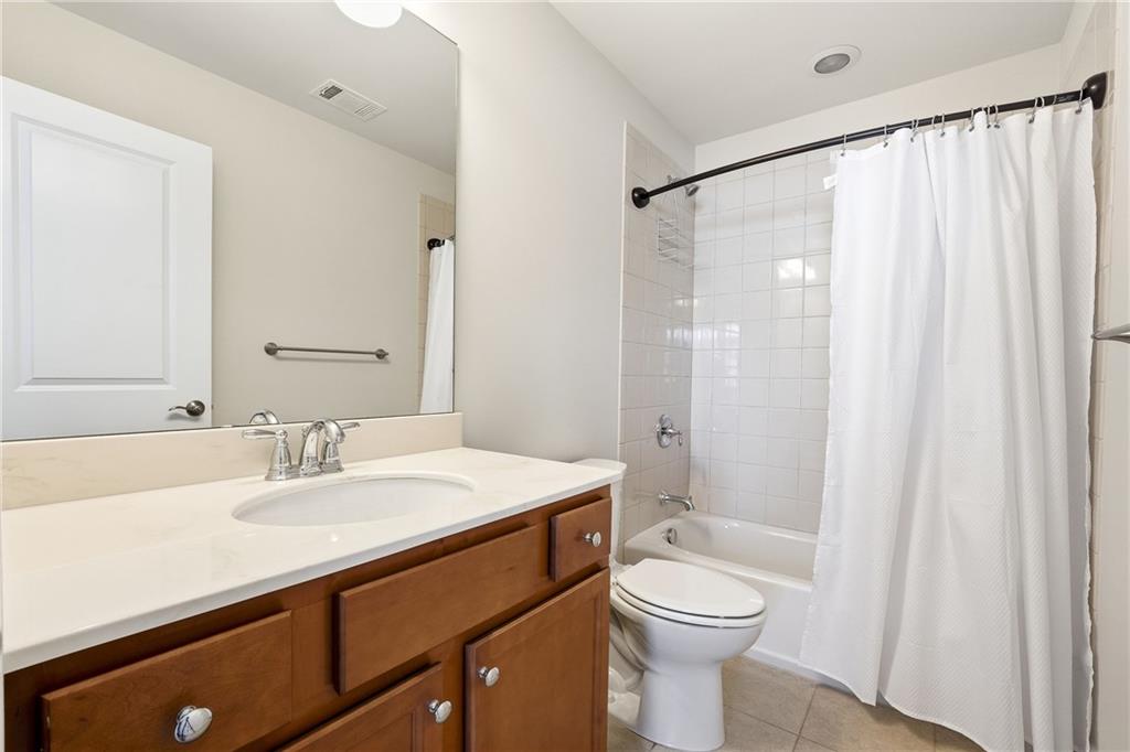 3751 Golden Leaf Point Southwest Gainesville, GA 30504 - Photo 24 of 45 a bathroom with a sink a toilet and shower