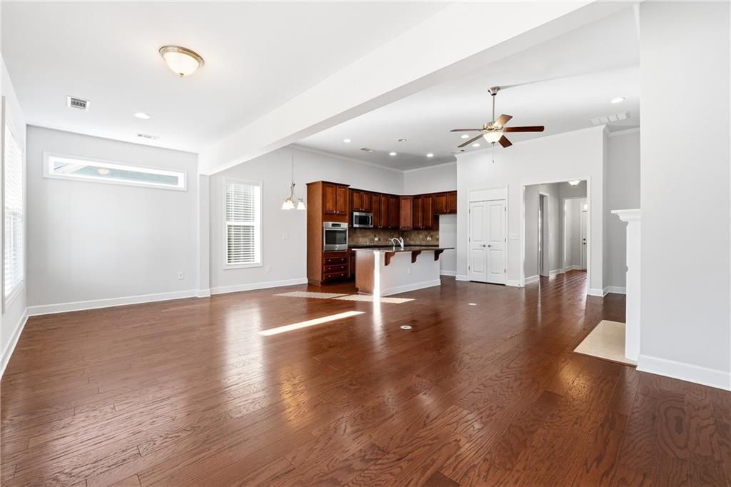 3751 Golden Leaf Point Southwest Gainesville, GA 30504 - Photo 10 of 45 a view of a living room and a kitchen with wooden floor