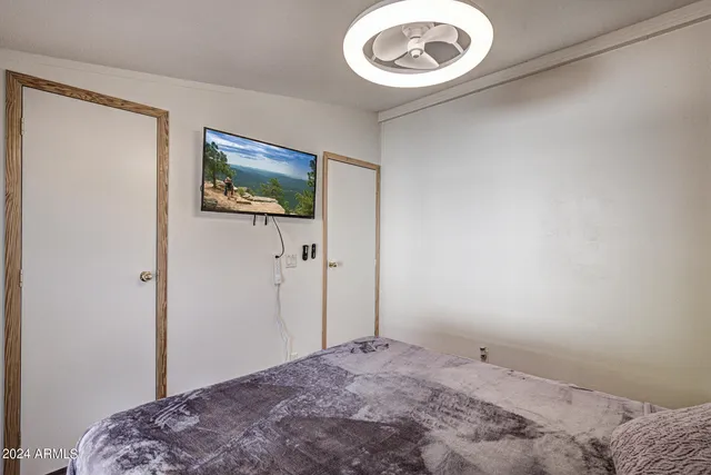 a bedroom with a bed and a painting on the wall