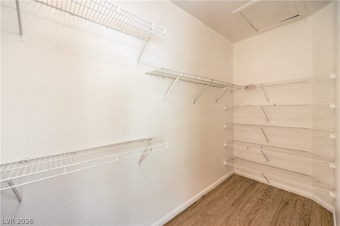 3713 Spring Shadow Road Las Vegas, NV 89129 - Photo 25 of 37 This convenient walk-in closet offers extensive wire shelving and durable hardwood-style flooring.