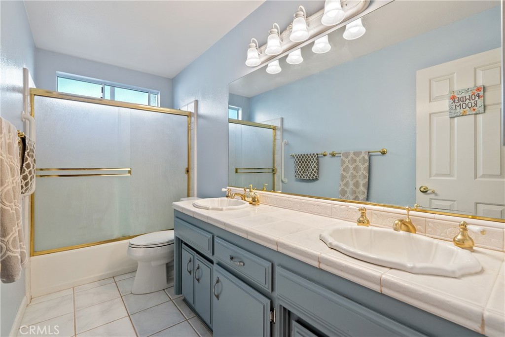 918 Inverness Drive Paso Robles, CA 93446 - Photo 18 of 38 a bathroom with a sink a toilet and shower