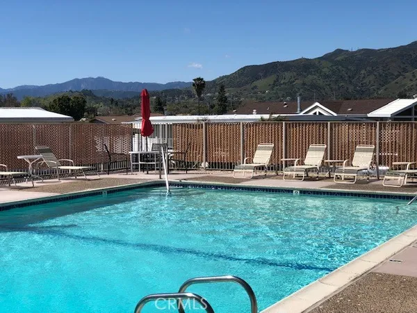 a view of a swimming pool with a yard