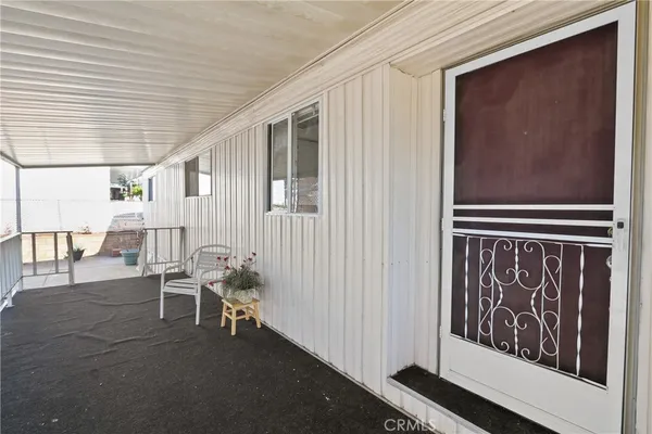 a couple of chairs sitting in front of a house