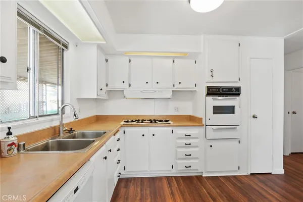 a kitchen with cabinets appliances and a sink