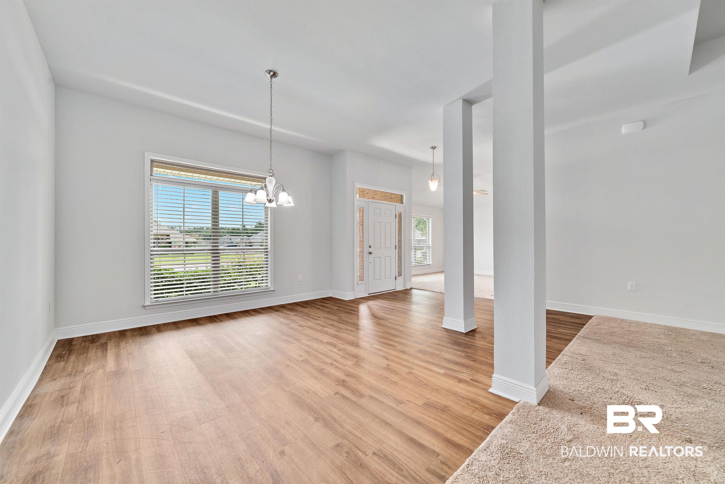 13155 Wishbone Court Foley, AL 36535 - Photo 7 of 39 Interior space featuring a wealth of natural light, wood-type flooring, and a chandelier