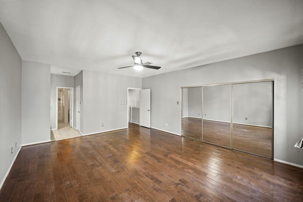 3780 Tanglewilde Street, Unit 306 Houston, TX 77063 - Photo 13 of 22 an empty room with wooden floor and windows