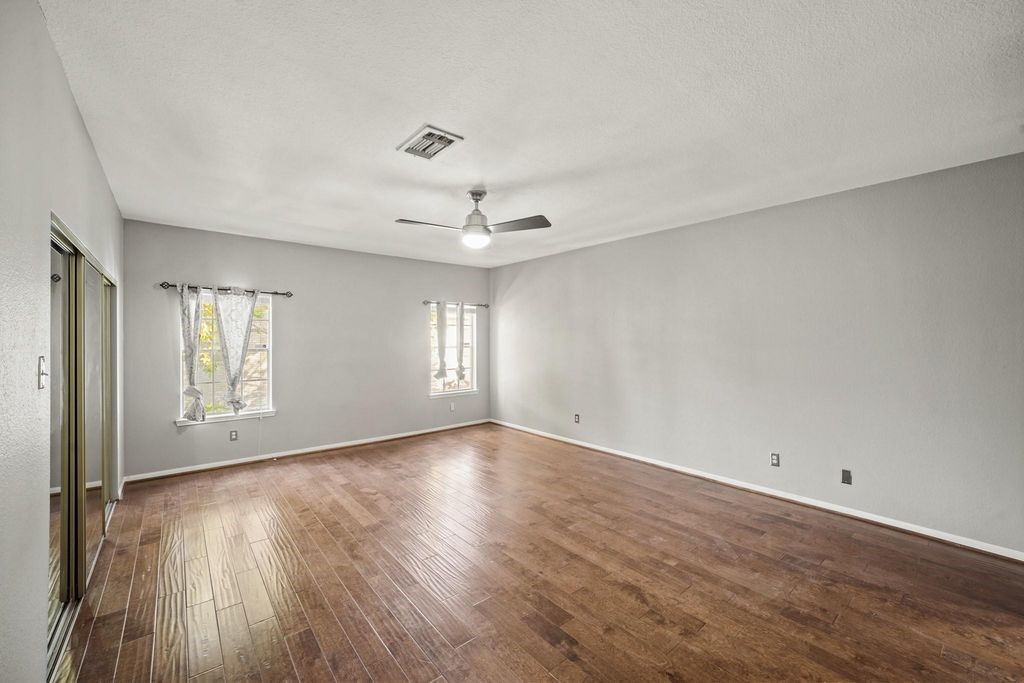 3780 Tanglewilde Street, Unit 306 Houston, TX 77063 - Photo 16 of 22 an empty room with wooden floor and windows