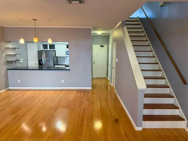 a view of a living room with entryway and stairs