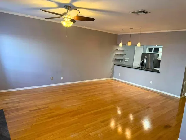 a view of a room with window and ceiling fan