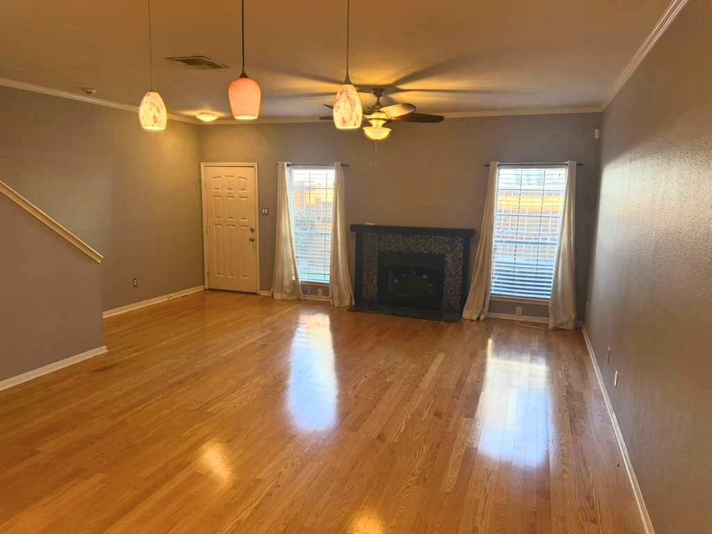3780 Tanglewilde Street, Unit 306 Houston, TX 77063 - Photo 7 of 22 an empty room with wooden floor fan and window