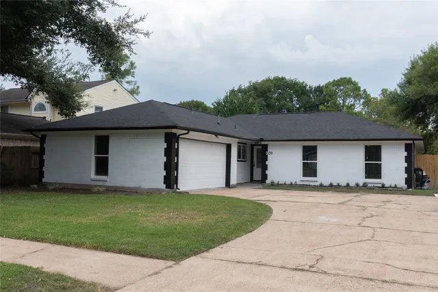 a front view of house with yard and trees