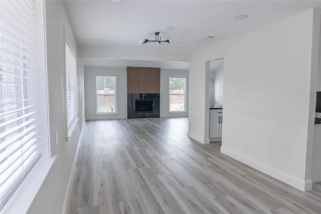 wooden floor in an empty room with a fireplace