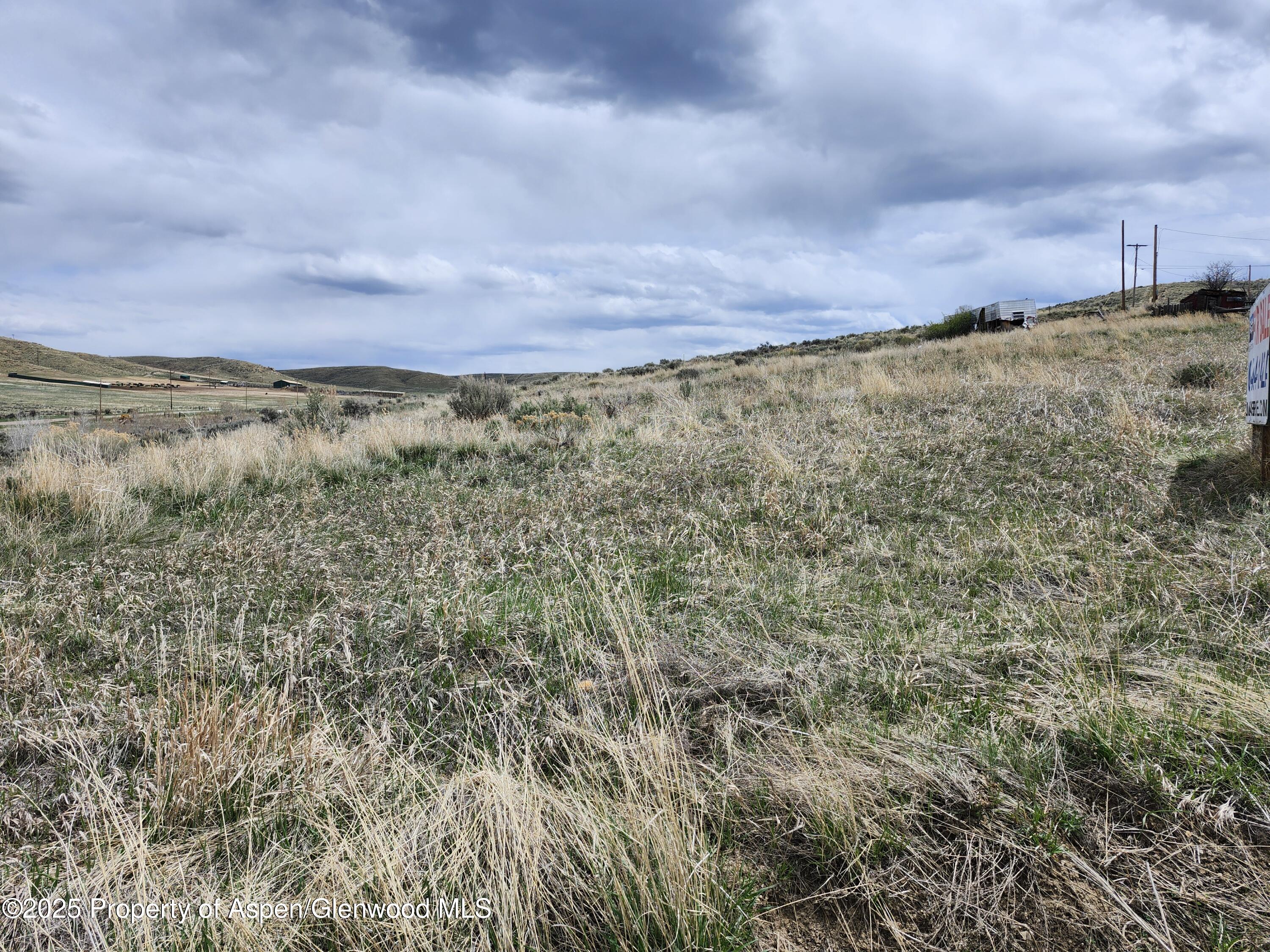 Tbd Pine Street Craig, CO 81625 - Photo 3 of 6 a view of a large building with a yard and wooden fence